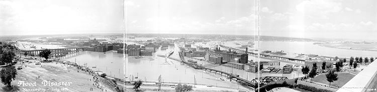 Panoramic view of the West Bottoms during the 1951 Flood. Spectators observe the damage from West Terrace Park, where Interstate 35 runs now.