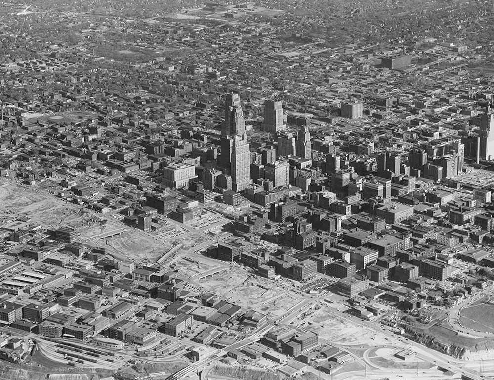 Aerial view of downtown captured early in the urban renewal era, showing evidence of building demolition and new construction, circa 1957. Kansas City Public Library.