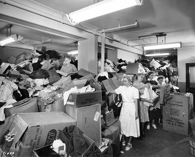 Salvation Army workers sort through clothing donated during the 1951 Flood.