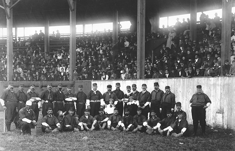 Unidentified Kansas City baseball team with dozens of fans in the grandstand, ca. 1880.
