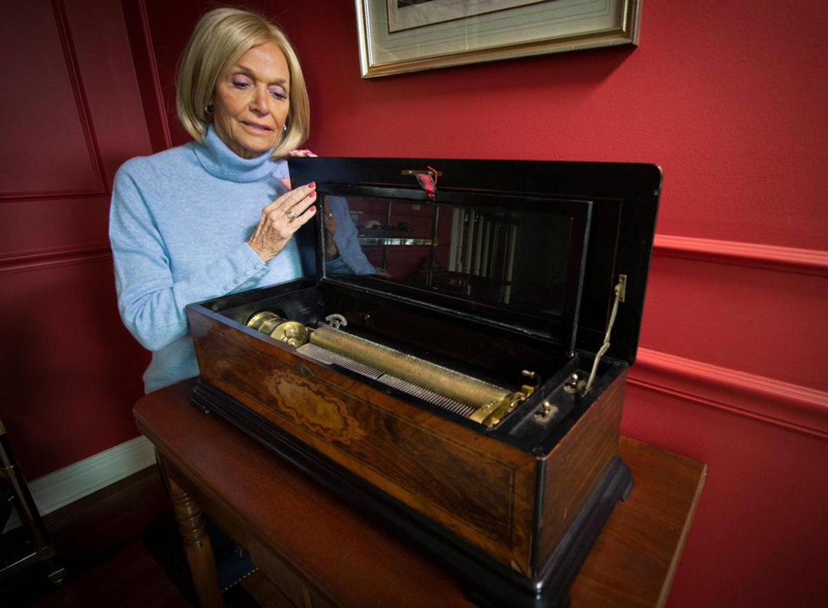 Carol Price looks over the treasured Swiss music box, an antique from The Willows, a maternity home for unwed, pregnant mothers that used to stand at 2929 Main Street in Kansas City. Price was born at and adopted from The Willows, which was founded by her grandparents. KANSAS CITY STAR, Tammy Ljungblad