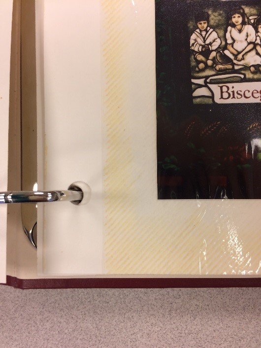 The adhesive and plastic used in magnetic scrapbook pages quickly damage the materials placed inside them. This scrapbook is only about 15 years old, but the pages are already discolored, a sign of deterioration.
