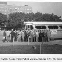 Group of Business Men in Front of Bus