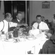 Men Seated at a Table with Boxer Jack Dempsey