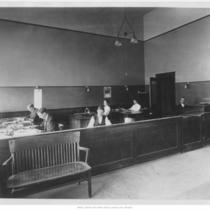 Men and Women Seated at Desks
