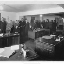Men and Women Posed around Desk