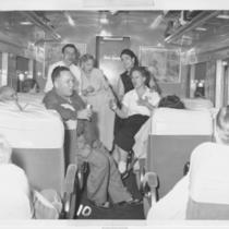 Men and Women Singing Aboard a Train