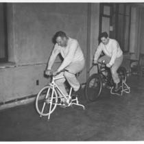 Men Riding Stationary Bicycles