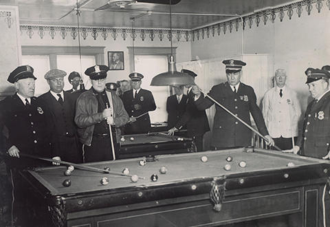 Police officers playing billiards